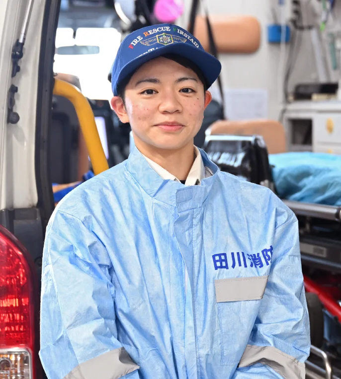 車の前に笑顔で立つ松浪さんの写真